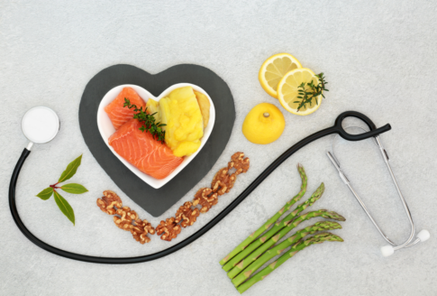 foods that lower cholesterol inside a heart and next to stethoscope