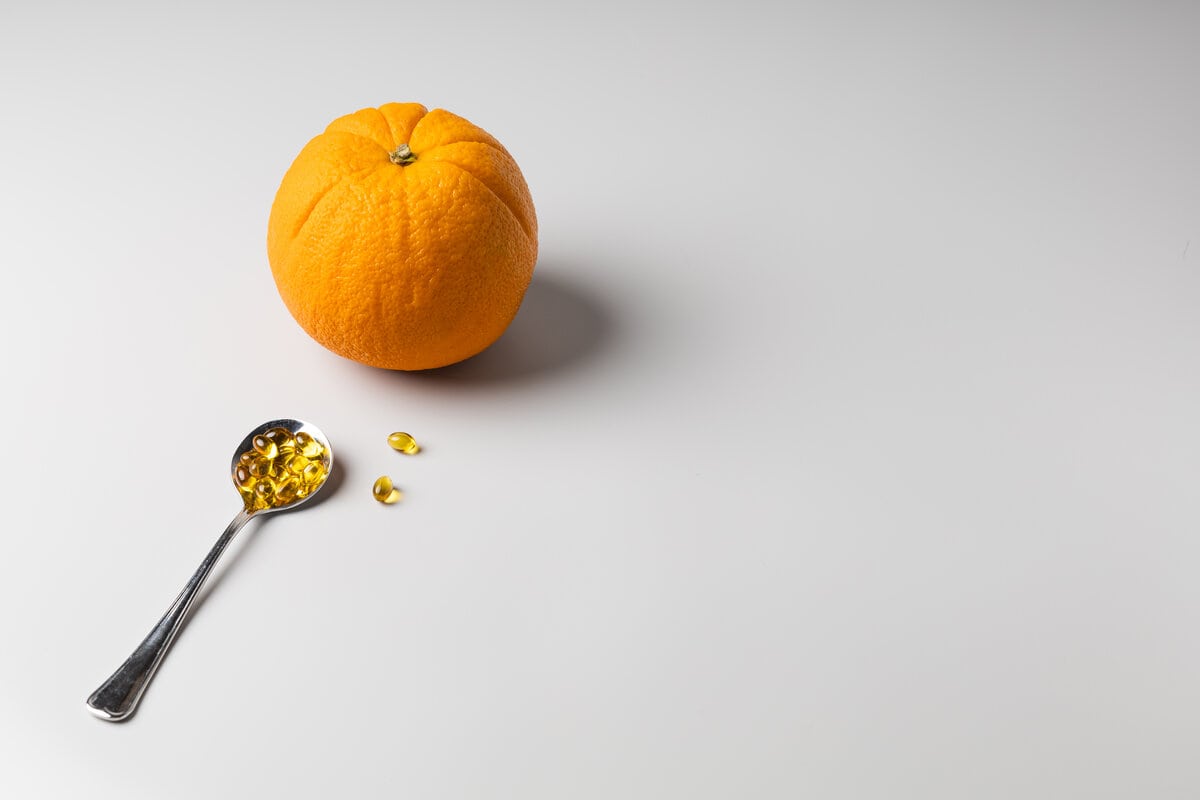 Orange and spoon with vitamin C.