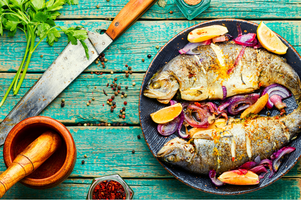 mediterranean palte wih grilled fish next to drill & knife