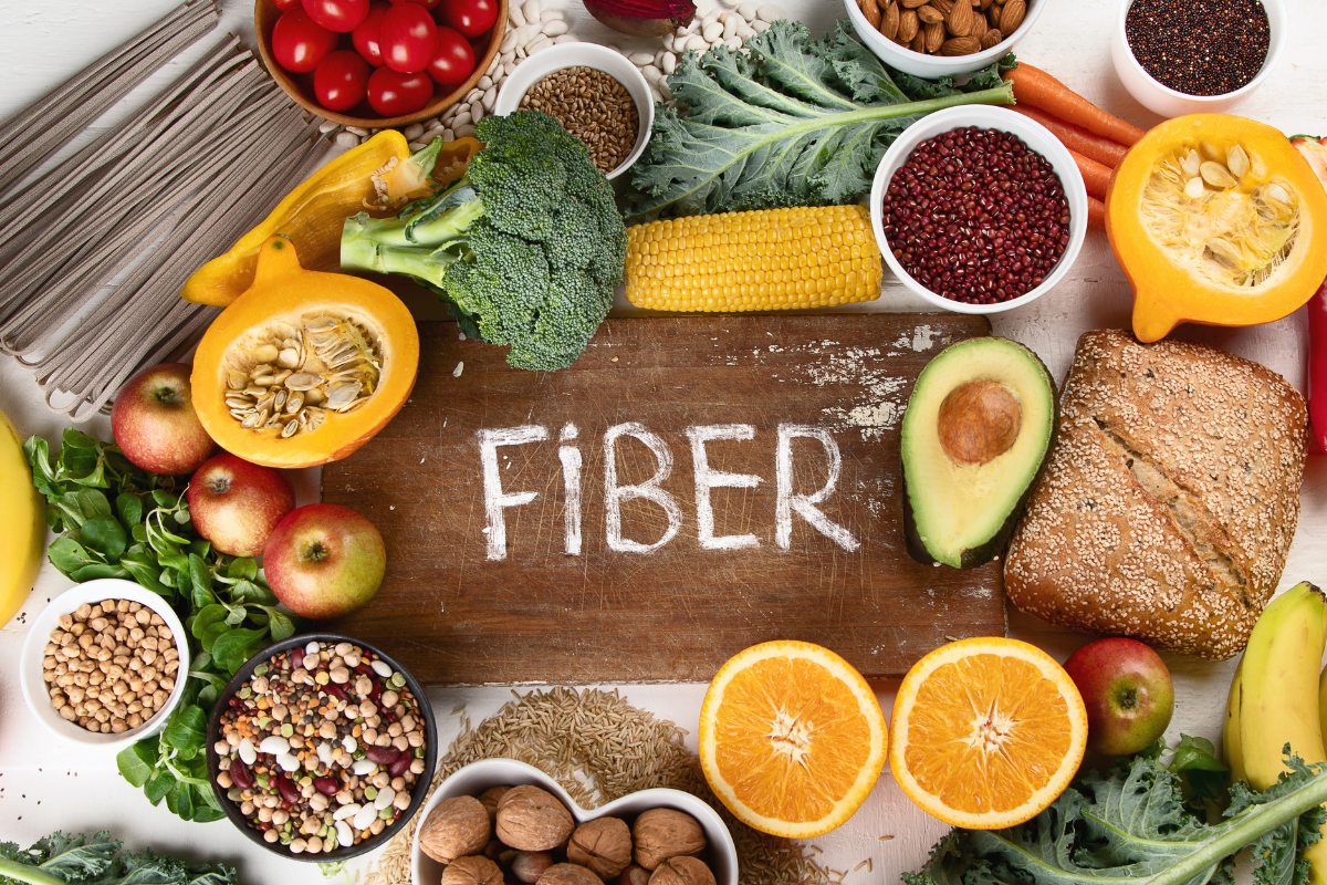 foods rich in fiber around wooden cutting board that writes fiber