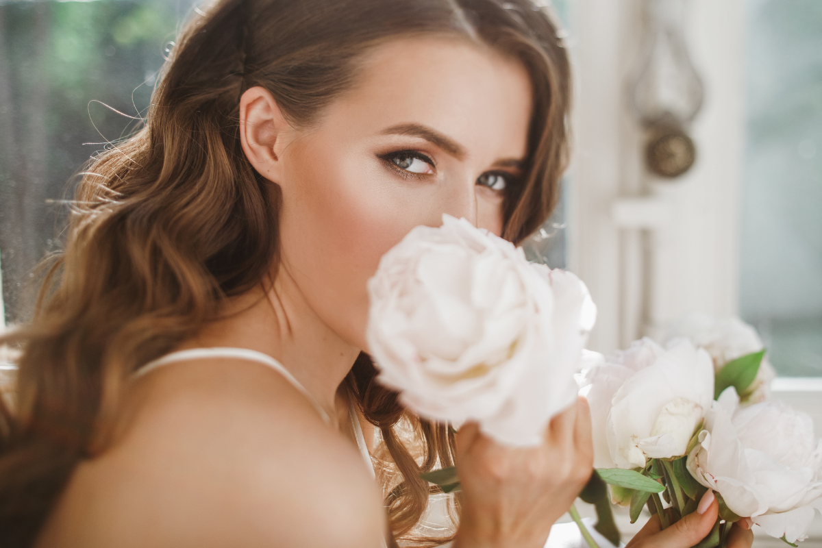 Young woman holding a white rose.