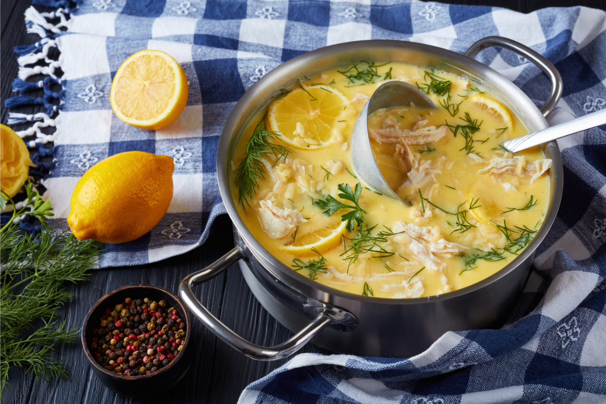 chickensoup in a pot over blue-white plaid tableclothe
