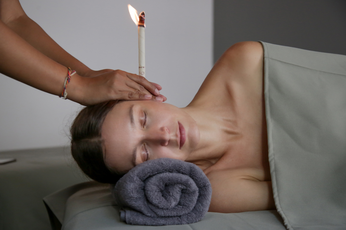 woman is having an earwax removal with fire