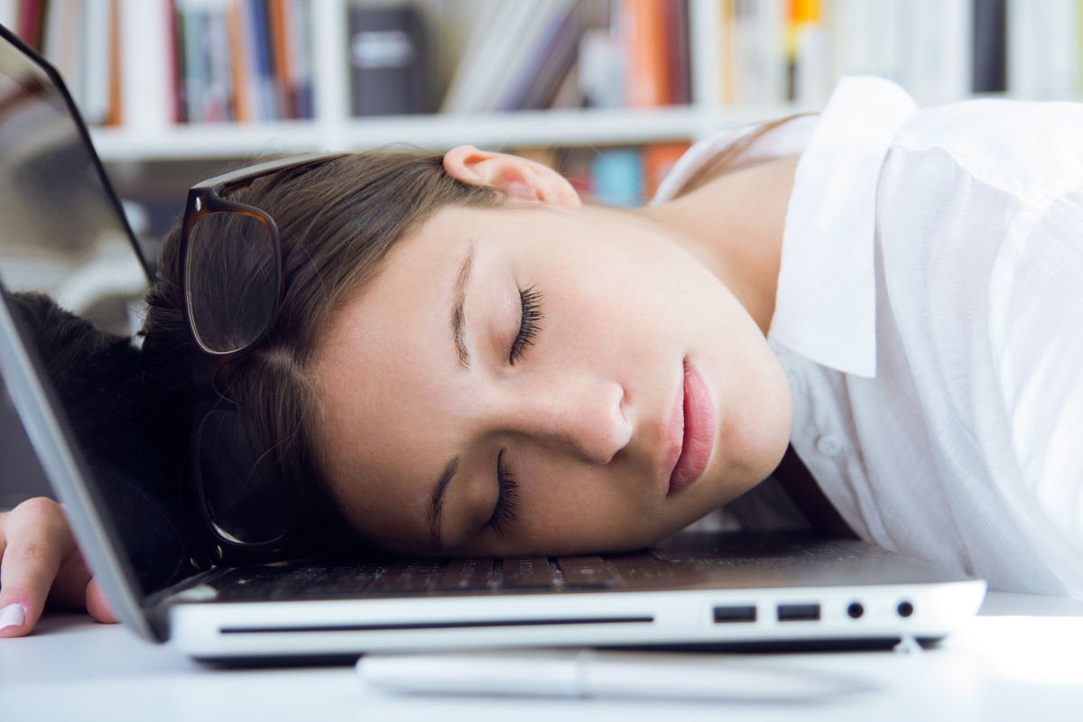woman sleeping on her laptop